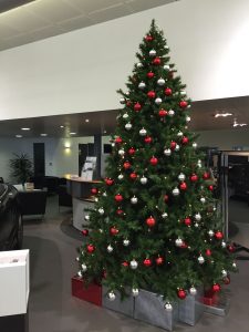 Decorated christmas tree in car showroom reception