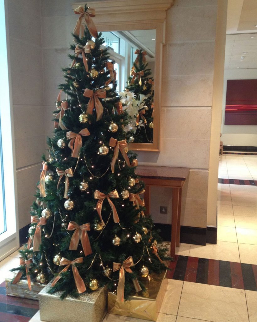 Christmas tree with golden ribbons and decorations